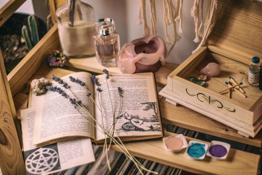 Test Aesthetic setup with books, lavender, crystals, and candles on a wooden shelf.